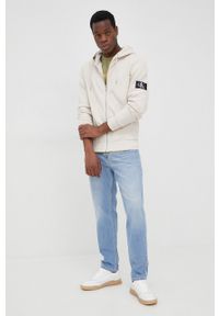 Calvin Klein Jeans bluza bawełniana męska kolor beżowy z kapturem gładka. Okazja: na co dzień. Typ kołnierza: kaptur. Kolor: beżowy. Materiał: bawełna. Wzór: gładki. Styl: casual