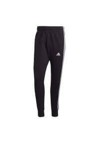 Adidas - Essentials French Terry Tapered Cuff 3-Stripes Pants. Kolor: biały, czarny, wielokolorowy. Materiał: dresówka