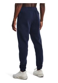 Under Armour Spodnie dresowe UA Essential Fleece Jogger 1373882 Granatowy Regular Fit. Kolor: niebieski. Materiał: bawełna, dresówka