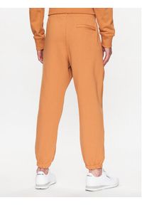 New Balance Spodnie dresowe MP23551 Pomarańczowy Relaxed Fit. Kolor: pomarańczowy. Materiał: bawełna