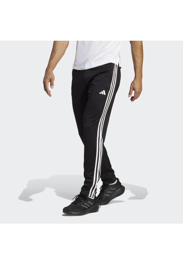 Adidas - Train Essentials 3-Stripes Training Pants. Kolor: wielokolorowy, biały, czarny. Materiał: dresówka, materiał. Sport: fitness