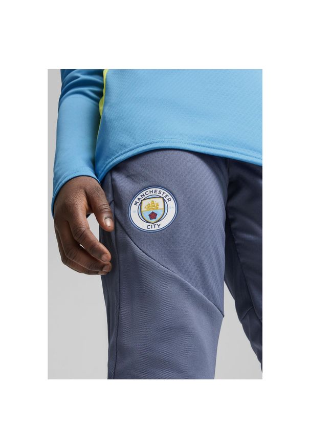 Puma - Młodzieżowe spodnie treningowe Manchester City PUMA Inky Blue Magic. Kolor: niebieski