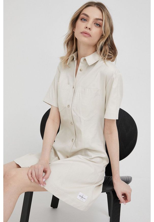 Calvin Klein Jeans sukienka bawełniana J20J218347.PPYY kolor beżowy mini prosta. Okazja: na co dzień. Kolor: beżowy. Materiał: bawełna. Długość rękawa: krótki rękaw. Typ sukienki: proste. Styl: casual. Długość: mini