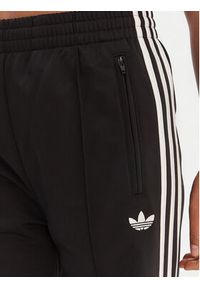 Adidas - adidas Spodnie dresowe Firebird KD7976 Czarny Loose Fit. Kolor: czarny. Materiał: syntetyk #4