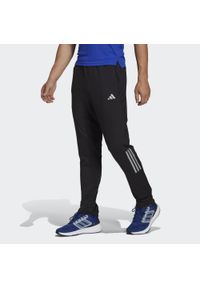 Adidas - Spodnie Own the Run Astro Knit. Kolor: czarny. Sport: bieganie