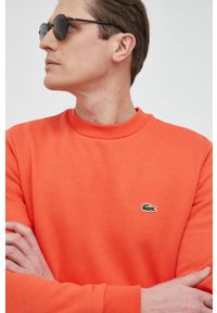Lacoste bluza męska kolor pomarańczowy gładka SH9608-132. Kolor: pomarańczowy. Materiał: bawełna, poliester. Wzór: gładki
