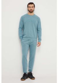 Guess spodnie dresowe kolor zielony melanżowe. Kolor: turkusowy. Materiał: dresówka. Wzór: melanż #2