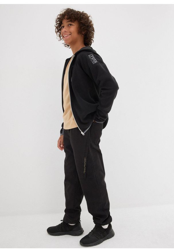 bonprix - Spodnie typu loose fit z podszewką z dżerseju. Kolor: czarny. Materiał: jersey