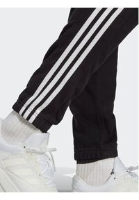 Adidas - adidas Spodnie dresowe Essentials French Terry Tapered Elastic Cuff 3-Stripes Joggers IC0050 Czarny Regular Fit. Kolor: czarny. Materiał: bawełna, dresówka