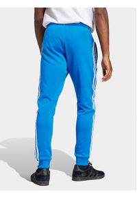 Adidas - adidas Spodnie dresowe adicolor Classics SST IM4542 Niebieski Slim Fit. Kolor: niebieski. Materiał: bawełna #4