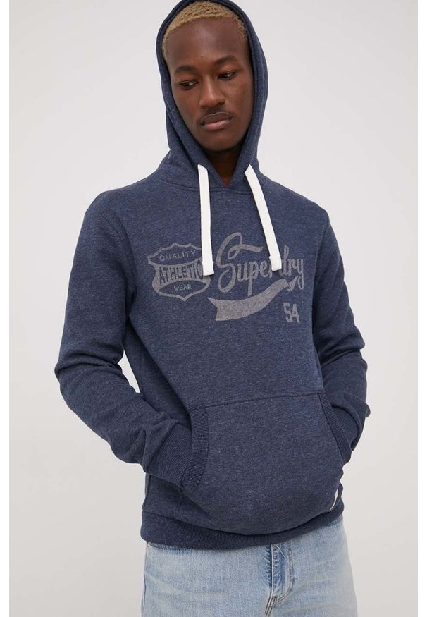 Superdry bluza męska kolor granatowy z kapturem z nadrukiem. Okazja: na co dzień. Typ kołnierza: kaptur. Kolor: niebieski. Wzór: nadruk. Styl: casual