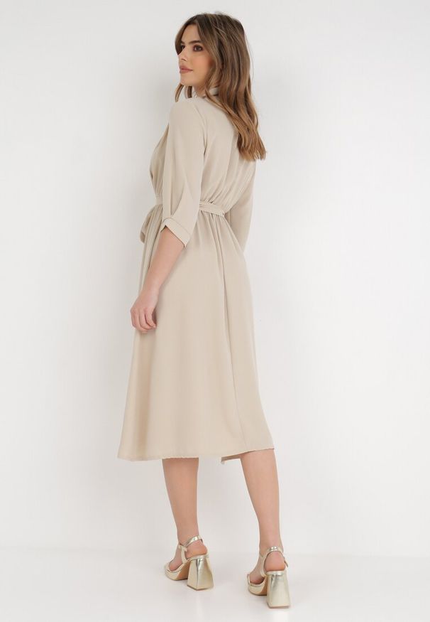Born2be - Beżowa Sukienka Rheniolea. Typ kołnierza: dekolt kopertowy. Kolor: beżowy. Typ sukienki: kopertowe. Styl: elegancki. Długość: midi