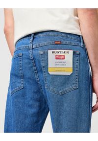 Wrangler - MĘSKIE SPODNIE JEANSOWE WRANGLER RUSTLER SLIM INDIGO MID W10ERC81D 112342563. Okazja: na co dzień. Sezon: lato. Styl: klasyczny, casual, elegancki #3