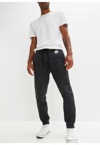 bonprix - Spodnie sportowe ocieplane, na polarowej podszewce. Kolor: czarny. Materiał: polar. Styl: sportowy #1