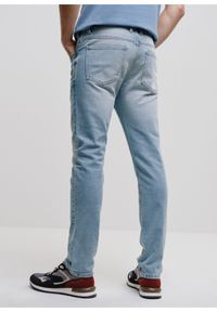 Ochnik - Niebieskie spodnie jeansowe męskie. Kolor: niebieski. Materiał: bawełna