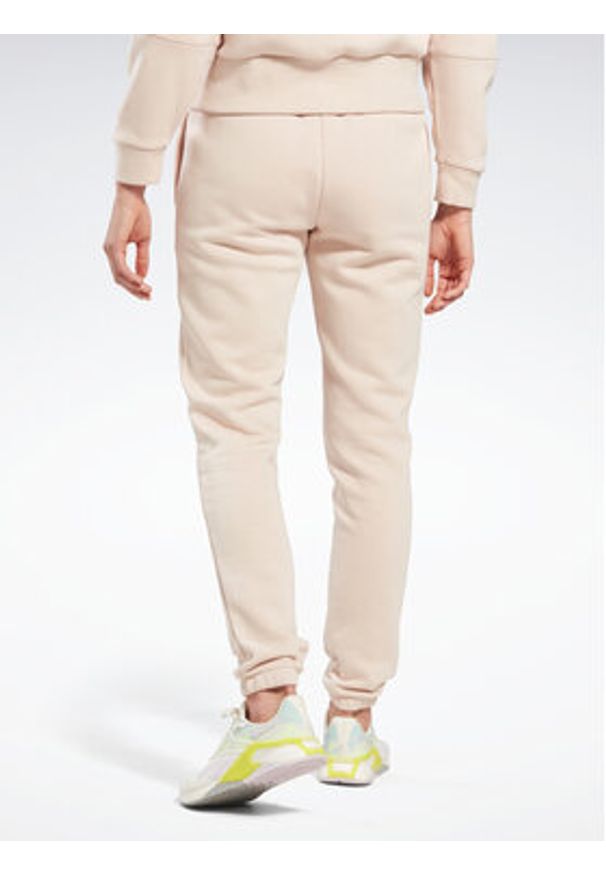 Reebok Spodnie dresowe Fleece IC3502 Beżowy Slim Fit. Kolor: beżowy. Materiał: bawełna