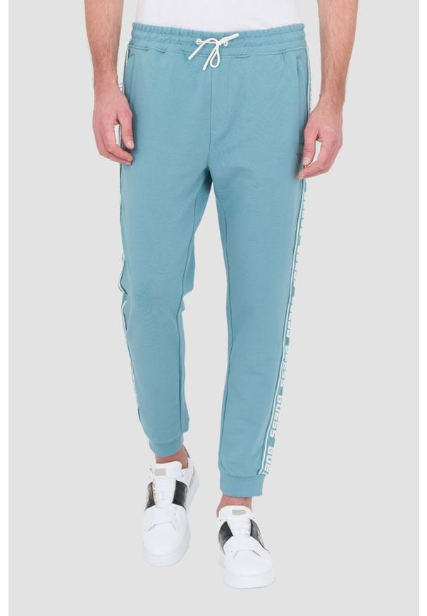 Guess - GUESS Turkusowe dresowe spodnie New Arlo. Kolor: niebieski. Materiał: dresówka