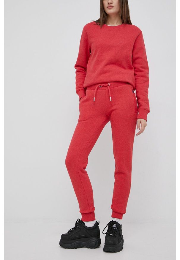 Superdry spodnie dresowe damskie kolor czerwony gładkie. Kolor: czerwony. Materiał: dresówka. Wzór: gładki