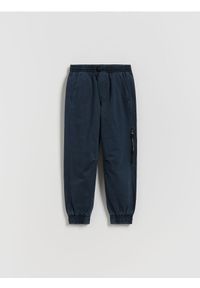 Reserved - Bawełniane spodnie jogger - granatowy. Kolor: niebieski. Materiał: bawełna #1
