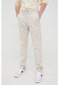 Guess spodnie męskie kolor beżowy w fasonie chinos. Kolor: beżowy. Materiał: tkanina. Wzór: gładki
