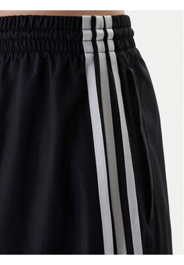 Adidas - adidas Spodnie dresowe Firebird Adilenium KD2914 Czarny Regular Fit. Kolor: czarny. Materiał: syntetyk