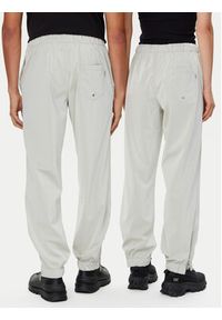 Rains Spodnie przeciwdeszczowe Unisex 18560 Beżowy Regular Fit. Kolor: beżowy. Materiał: syntetyk #6