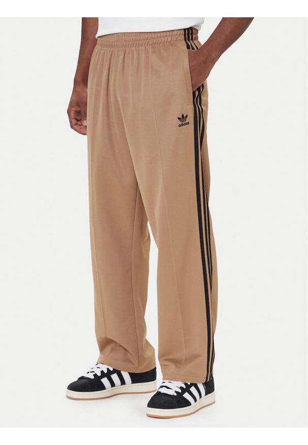 Adidas - adidas Spodnie dresowe adicolor Firebird JY1419 Beżowy Baggy Fit. Kolor: beżowy. Materiał: syntetyk, bawełna