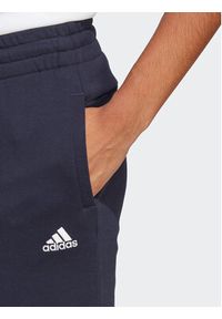 Adidas - adidas Spodnie dresowe Essentials Linear IC6869 Granatowy Slim Fit. Kolor: niebieski. Materiał: bawełna