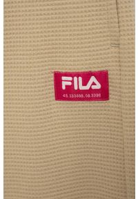 Fila spodnie dresowe dziecięce kolor beżowy gładkie. Stan: podwyższony. Kolor: beżowy. Materiał: dresówka. Wzór: gładki #3