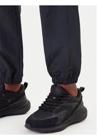 Reebok Spodnie dresowe Vector 100221435 Czarny Relaxed Fit. Kolor: czarny. Materiał: syntetyk