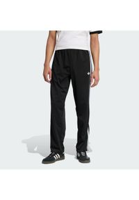 Adidas - adidas Spodnie dresowe Firebird KD8315 Czarny Loose Fit. Kolor: czarny. Materiał: syntetyk #1