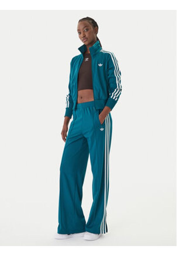 Adidas - adidas Spodnie dresowe Firebird KG3701 Zielony Loose Fit. Kolor: zielony. Materiał: syntetyk