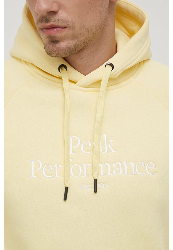 Peak Performance bluza męska kolor żółty z kapturem z aplikacją. Okazja: na co dzień. Typ kołnierza: kaptur. Kolor: żółty. Materiał: bawełna, dzianina. Długość rękawa: raglanowy rękaw. Wzór: aplikacja. Styl: casual