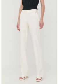 Marciano Guess spodnie damskie kolor beżowy proste medium waist. Okazja: na co dzień. Kolor: beżowy. Materiał: tkanina. Styl: casual