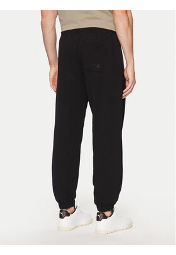 Guess Spodnie dresowe Z4YB00 KAIJ1 Czarny Relaxed Fit. Kolor: czarny. Materiał: bawełna