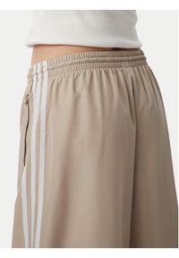 Adidas - adidas Spodnie dresowe Firebrid Adilenium Track KT0019 Beżowy Relaxed Fit. Kolor: beżowy. Materiał: syntetyk #5