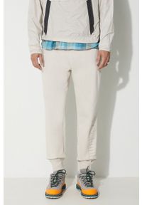columbia - Columbia spodnie dresowe męskie kolor beżowy gładkie. Kolor: beżowy. Materiał: dresówka. Wzór: gładki