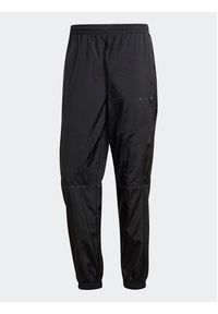 Adidas - adidas Spodnie dresowe Reveal Material Mix HK2732 Czarny Regular Fit. Kolor: czarny. Materiał: syntetyk, dresówka