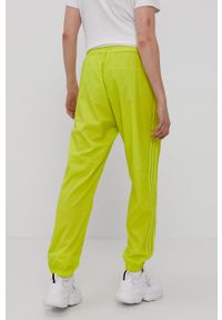 adidas Originals Spodnie dwustronne męskie kolor żółty gładkie. Kolor: żółty. Materiał: poliester. Wzór: gładki #7