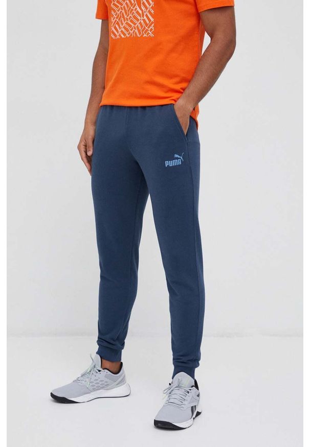 Puma spodnie dresowe kolor granatowy gładkie. Kolor: niebieski. Materiał: dresówka. Wzór: gładki