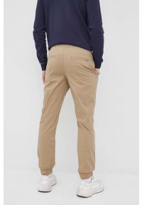 Selected spodnie męskie kolor beżowy joggery. Kolor: beżowy. Materiał: tkanina, bawełna. Wzór: gładki