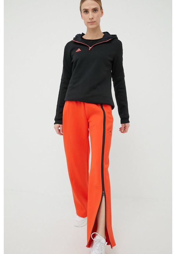 Adidas by Stella McCartney - adidas by Stella McCartney spodnie dresowe H59285 damskie kolor pomarańczowy z nadrukiem. Kolor: pomarańczowy. Materiał: dresówka. Wzór: nadruk