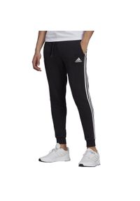 Adidas - Spodnie Essentials Slim 3 Stripes Rozmiar M Czarny - GM1089. Kolor: czarny. Wzór: paski, aplikacja