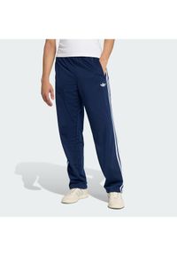 Adidas - adidas Spodnie dresowe Firebird KD8316 Granatowy Loose Fit. Kolor: niebieski. Materiał: syntetyk #1