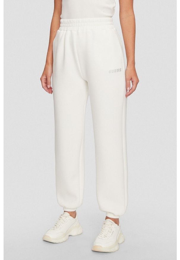 Guess - GUESS Dresowe damskie spodnie w kolorze ecru Cecilia Scuba, Rozmiar M. Kolor: beżowy. Materiał: dresówka