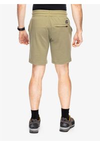 SUPER.NATURAL - Spodenki męskie Super.natural Solution Shorts. Kolor: zielony. Sport: turystyka piesza