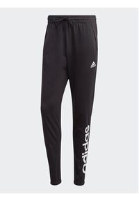 Adidas - adidas Spodnie dresowe Essentials Single Jersey Tapered Elasticized Cuff Logo Joggers IC0055 Czarny Regular Fit. Kolor: czarny. Materiał: bawełna #4