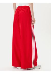Adidas - adidas Spodnie dresowe adicolor Firebird JD3388 Czerwony Loose Fit. Kolor: czerwony. Materiał: syntetyk #3