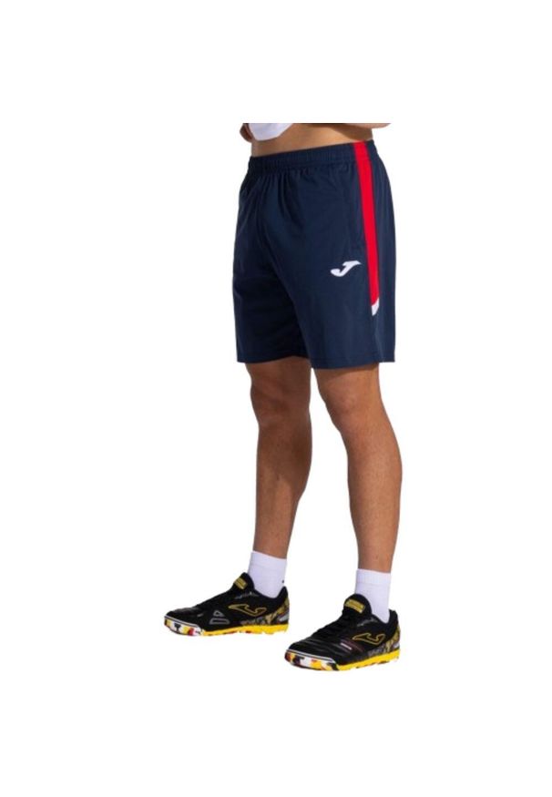 Krótki Chłopak Joma Montreal II niebieski. Kolor: czerwony, niebieski, wielokolorowy. Materiał: materiał. Długość: krótkie. Sezon: lato. Sport: fitness