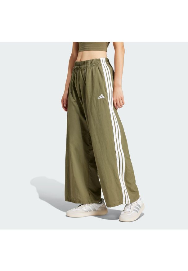 Adidas - Spodnie Essentials 3-Stripes Lifestyle Woven Parachute. Kolor: biały, wielokolorowy, beżowy. Materiał: materiał